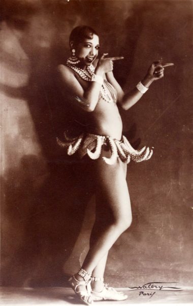 Joséphine Baker in Banana Skirt from the Folies Bergère production “Un Vent de Folie.”. Photo by Lucien Waléry (c. 1927). PD-70+. Wikimedia Commons. 