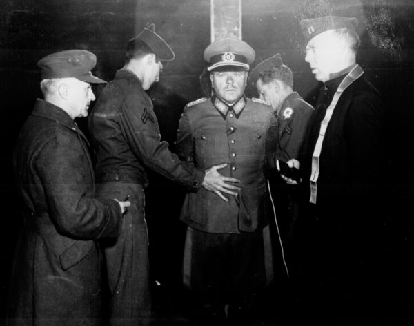 German General Anton Dostler is tied to a stake before his execution by firing squad. Photo by Blomgren (1 December 1945). National Archives. PD-US Government. Wikimedia Commons. 