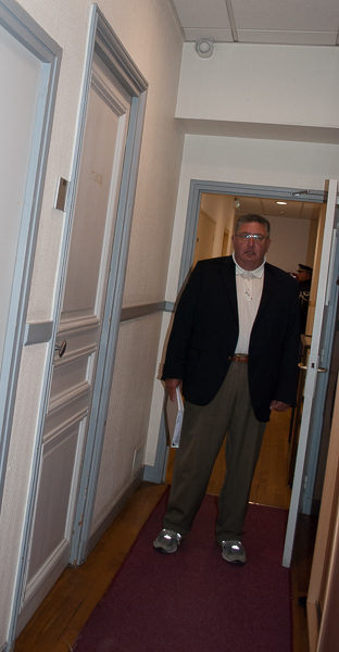 Stew standing in the hallway of the former headquarters of the Gestapo. Cell doors lined the hallway. Photo by Sandy Ross. 