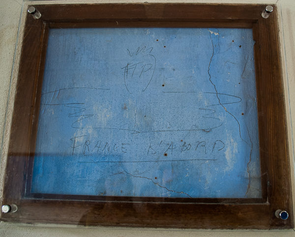 Graffiti written by the prisoners inside the Mont-Valérien chapel immediately before being taken to their execution. Photo by Sandy Ross.