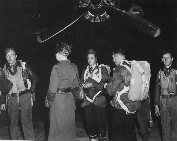 Jedburghs in front of a B-24 just before night takeoff. Photo by anonymous (c. 1944). U.S. National Archives and Records Administration. PD-Free License. Wikimedia Commons. 