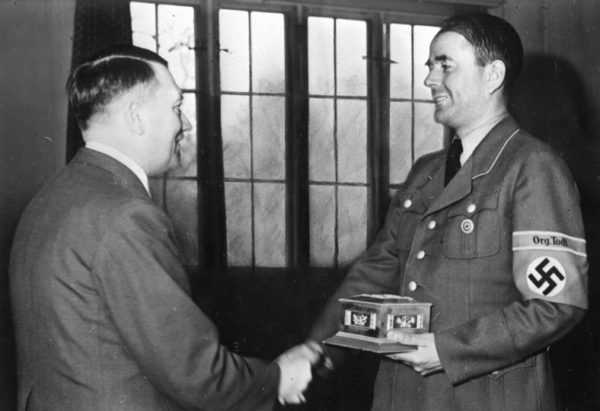 Adolf Hitler gives Albert Speer the Fritz-Todt-Ring. Photo by Heinrich Hoffmann (May 1943). Bundesarchiv, Bild 146-1979-026-22/Hoffmann, Heinrich/CC-BY-SA 3.0. PD-Creative Commons Attribution-Share Alike 3.0 Germany. Wikimedia Commons. 
