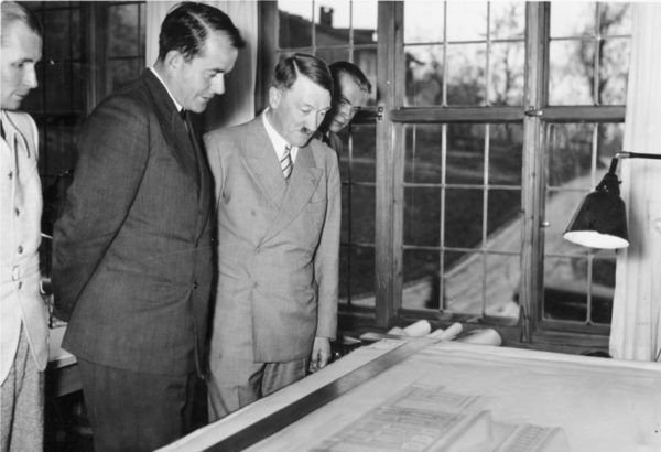 Adolf Hitler and Albert Speer (second from left) at Obersalzberg looking at a plan for the new Opera of Linz. Photo by Heinrich Hoffmann (21 June 1939). Bundesarchiv, Bild 183-2004-1103-500/CC-BY-SA 3.0. PD-Creative Commons Attribution-Share Alike 3.0 Germany. Wikimedia Commons.