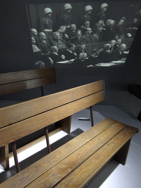 Original courtroom benches on which accused Nazi leaders sat. Photo by Adam Jones, Ph.D. (2012). Palace of Justice Exhibition at Memorium Nuremberg Trials. PD-Creative Commons Attribution-Share Alike 3.0. Wikimedia Commons. 