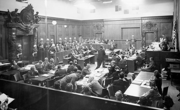 Robert Jackson, US Chief Prosecutor, presents the case against the defendants to the court at the main Nuremberg Trial. Photo by US Army (c. September 1945). PD-US Government. Wikimedia Commons.