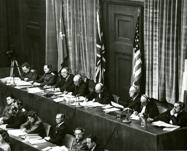 View of the judges panel at the main Nuremberg Trial. Left to right: Soviet Union, Britain, United States, and France. Each country was represented by a primary judge and one alternate judge. Photo by US Army (c. 1945). PD-US Government. Wikimedia Commons. 