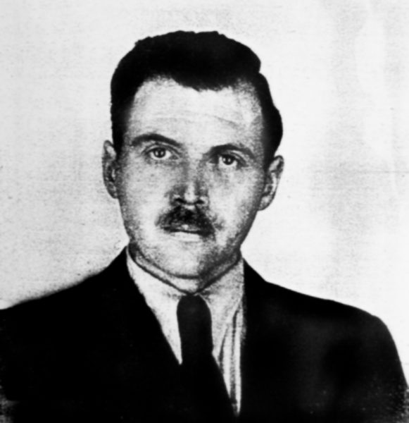 Josef Mengele, German SS office. Photo used for Mengele’s Argentine identification document. Photo by police photographer in Buenos Aires (c. 1956). PD-Expired Argentina Copyright. Wikimedia Commons. 