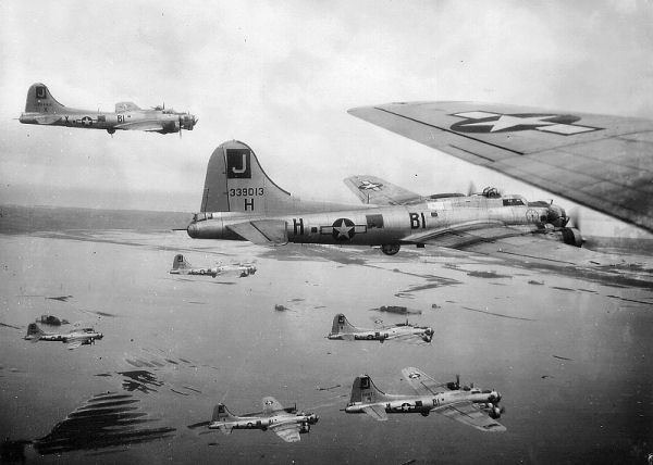 B-17s of the 390th Bomb Group, flying in formation out of RAF Framlingham, England. Photo by anonymous (c. 1942−1945). National Archives. PD-USGOV. Wikimedia Commons. 