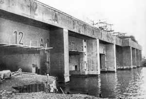 The entrance to the German U-boat pens at Saint-Nazaire. Photo by anonymous (April 1943). Imperial War Museum. PD-UKGOV. Wikimedia Commons. 