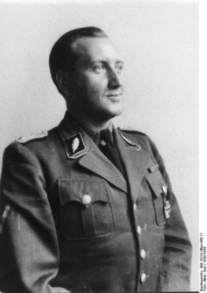 Helmut Knochen, SS-Standartenführer—Head of the Paris Gestapo. Photo by Kurt Alber (c. 1942). Bundesarchiv, Bild 101III-Alber-096-11/Alber, Kurt/CC-BY-SA 3.0. PD-Creative Commons Attribution-Share Alike 3.0 Germany. Wikimedia Commons. 