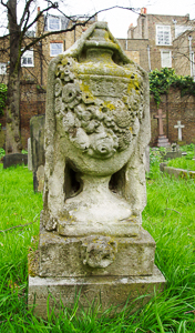 Example of urn drapped with mourning cloth. Photo by Boondoxatron (2007). Brompton Cemetery, London. PD-Author release. Wikimedia Commons. 