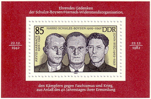 East German (DDR) stamp honoring the leaders of Die Rote Kapelle. Arvid Harnack on the left, Harro Schulze-Boysen in the center, and John Sieg to the right. Photo by Radzuweit (2007). Stamp design by unknown (1983). Wikimedia Commons. 