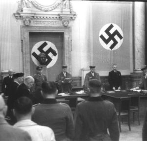 The People’s Court. Roland Freisler stands in the middle to the right of Hitler’s bust. Photo by anonymous (1944). German Federal Archives. PD-Bundesarchiv, Bild 151-39-21/CC-BY-SA 3.0. Wikimedia Commons. 