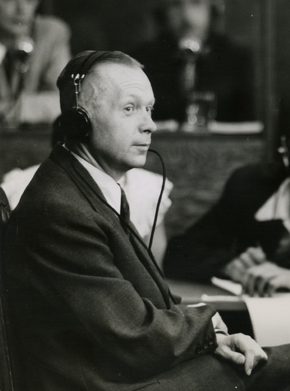 Manfred Roeder testifying for the prosecution at the Nuremberg Trials. Photo by U.S. Army Office of the Chief Counsel for War Crimes (1947). Harvard Law School Library. PD-U.S. Government. Wikimedia Commons. 