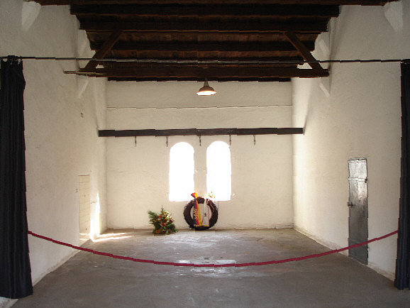 Inside the execution chamber at Plötzensee Prison. Notice the meat hooks in the rear of the room. The guillotine was set up in the foreground. Photo by MisterBee1966 (2007). PD-GNU Free Documentation License. Wikimedia Commons. 