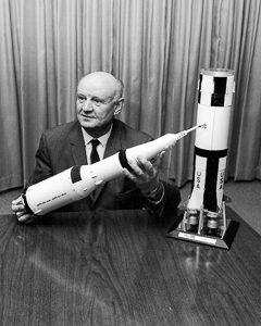 Arthur Rudolph holds a model of the Saturn V rocket. Photo by NASA (date unknown). PD-U.S. Government. Wikimedia Commons. 