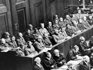 The Doctors’ Trial held in Nuremberg. Hitler’s personal physician, Karl Brandt, sits in first row, first seat on left. Dr. Kurt Blome sits in first row, seventh from the left. Photo by U.S. Army photographer (c. 9 December 1946 to 20 August 1947). United States Holocaust Memorial Museum. PD-U.S. Government. Wikimedia Commons. 