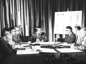 Dr. Wernher von Braun (center) and his management team. Photo by NASA (c. 1961). PD-U.S. Government. Wikimedia Commons. 