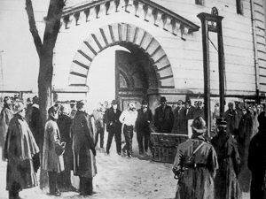 Landru walking to the guillotine outside the main entrance to La Prison Saint-Pierre à Versailles. Illustration by anonymous (25 February 1922). 