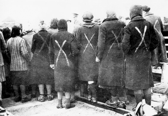 Female prisoners in Ravensbrück waiting to be evacuated. Photo by anonymous (c. April 1945). Courtesy of the Swedish Red Cross. PD-70+. Wikimedia Commons.