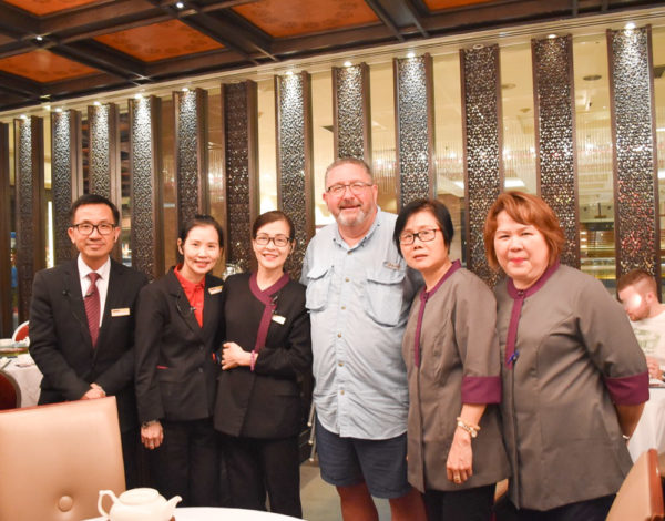 Stew (the guy who looks like he just returned from fishing) with the wait staff of Crystal Jade Palace. Photo by Sandy Ross (2019).