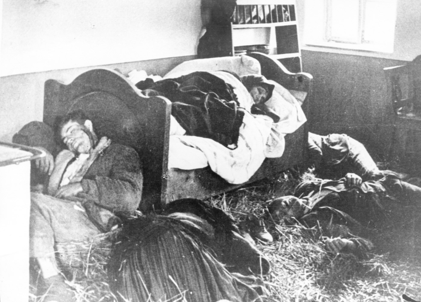 Serbian family lies slaughtered in their home following a raid by the Ustaša militia. Photo by anonymous (c. 1941). United States Holocaust Memorial Museum. Courtesy of Muzej Revolucije Narodnosti Jugoslavije. PD-Released to public domain. Wikimedia Commons.