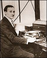 William Friedman in front of an AT&T cipher machine. Photo by anonymous (c. 1919). PD-Published prior to 1924. Wikimedia Commons.