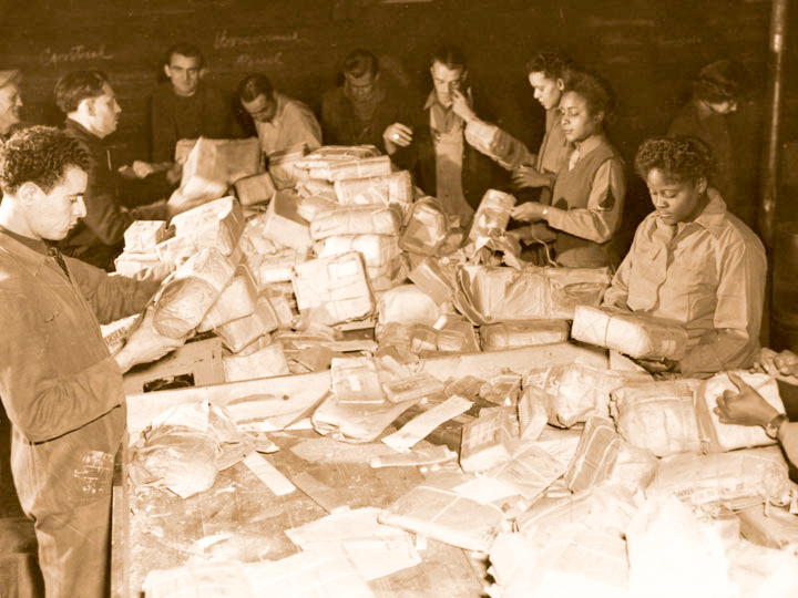 Members of the 6888th work with French civilians to sort the mail. Photo by anonymous (c. 1945). Courtesy of U.S. Army Women’s Museum.