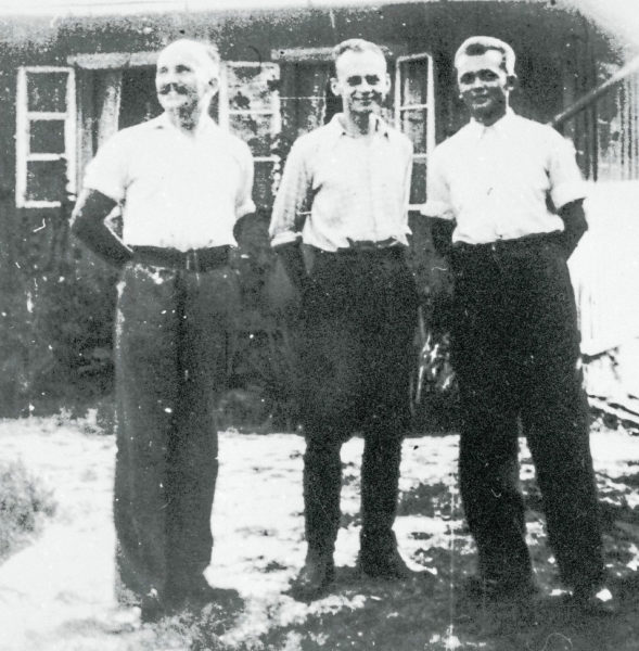 Witold Pilecki (center) and two other Auschwitz escapees standing in front of farmhouse used as a “safe” house after their escape. Photo by anonymous (c. summer 1943).