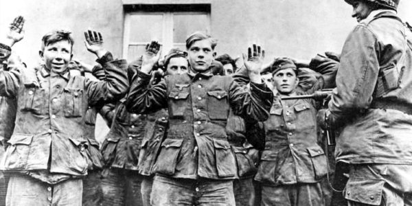 Young German soldiers surrendering to American troops. Photo by anonymous (c. April 1945).