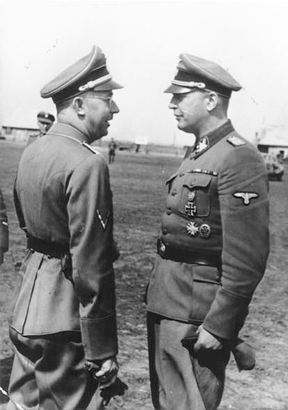 Heinrich Himmler (left) meets with Hans-Adolf Prützmann (right) in the Ukraine. Photo by anonymous (September 1942). United States Holocaust Memorial Museum. PD-Free Content. Wikimedia Commons.