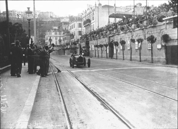 W. Williams crossing the finish line to win the inaugural 1929 Monaco Grand Prix. Photo by anonymous (1929). Bibliothèque nationale de France. PD-70+. Wikimedia Commons.