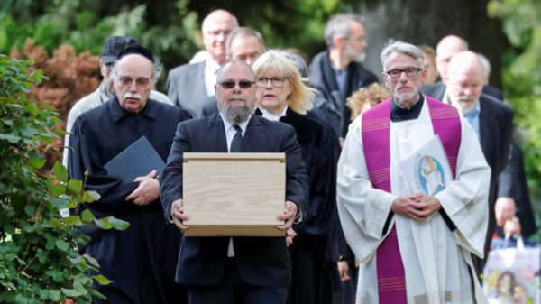 Procession to bury small coffin containing slides of human tissue from women prisoners executed by the Nazis. Photo by anonymous (c. 2019). Reuters – BBC.