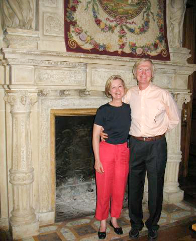 Claire (left) and Ken (right) Kirk in front of the Château RiveSarthe main fireplace. Photo by anonymous (c. 2006). Courtesy of Ken Kirk.