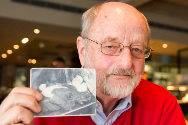 Niklas Frank holding the photo of his father, Hans Frank, moments after the elder’s execution by hanging. Photo by Ian Vogler (date unknown). The Daily Mirror.