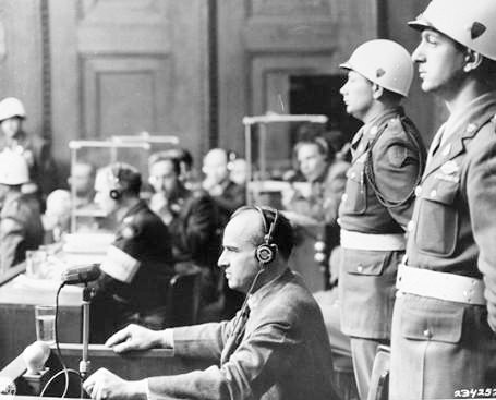 Hans Frank, former Nazi Governor General of Poland, in the witness box at the International Military Tribunal trial of war criminals at Nuremberg. Photo by anonymous (19 April 1946). National Archives, courtesy of USHMM Photo Archives. PD-U.S. Government. Wikimedia Commons.