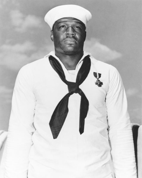 Doris Miller and his Navy Cross medal. Photo by anonymous (c. 1943).