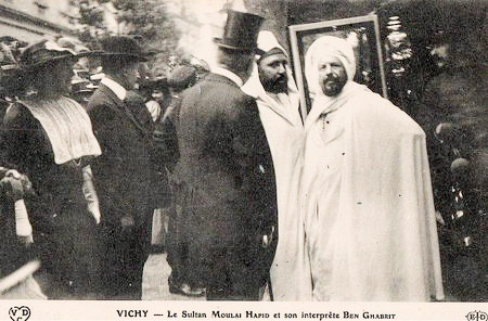 The Sultan of Morocco, Mulai Abdelhafid (second from right) and his translator, Benghabrit (far right) meeting French dignitaries in Vichy. Photo by anonymous (c. 1912). 
