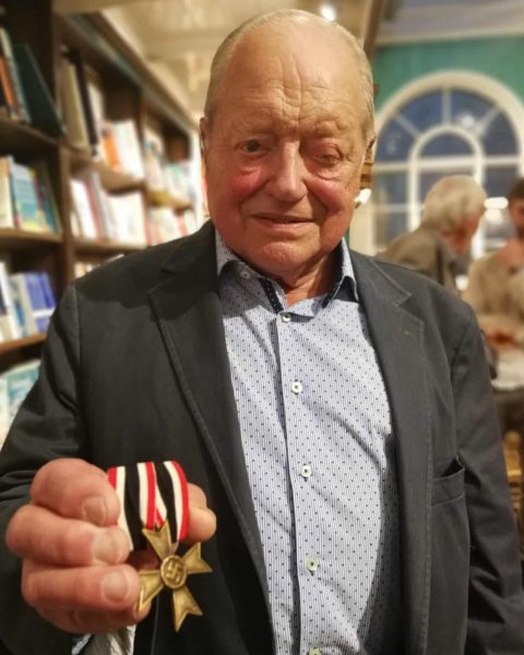 Ernest Kohout with the Nazi medal, faked by the Royal Mint owned by Lord Rothschild, which he discovered after the death of his father, Hans Kohout. Photo by anonymous (date unknown). 