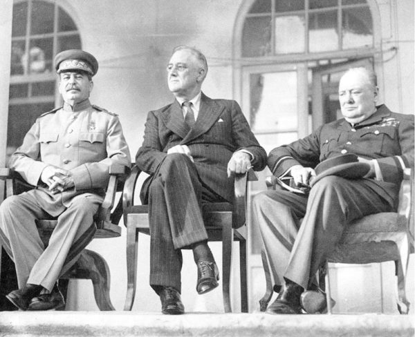 The Allied “Big Three” at the Tehran Conference: Stalin (left), Roosevelt (center), and Churchill (right). Photo by U.S. Government (c. November 1943). PD-U.S. Government. Wikimedia Commons. 