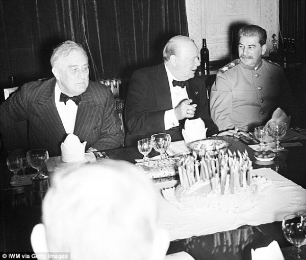 Roosevelt (left), Churchill (center), and Stalin (right) at dinner during the Tehran Conference. Photo by anonymous (c. November 1943). ©️ IWM via Getty Images.