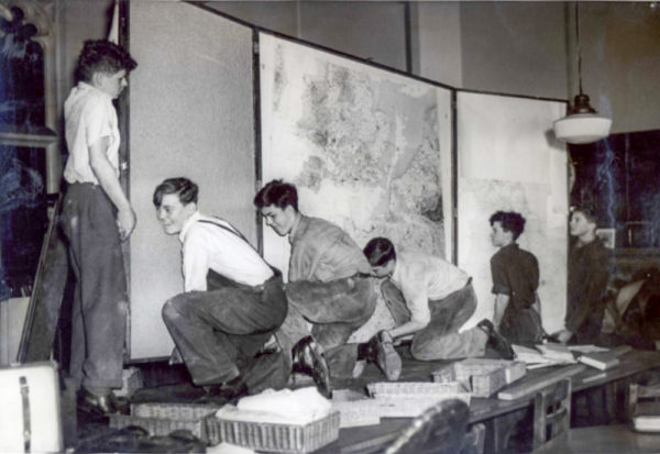 Recovered invasion maps being set-up in the Montgomery Room at the new St. Paul’s School. Photo by anonymous (date unknown). 