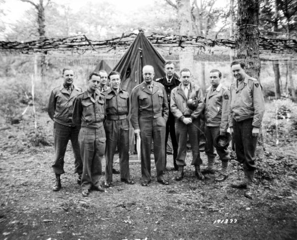 General Eisenhower (center) with staff at his new command post. Photo by anonymous (1 June 1944). Conseil Régional de Basse-Normandie/US National Archives.