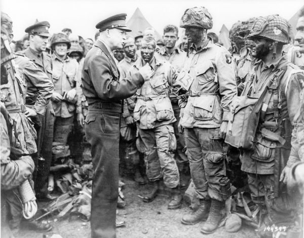 General Eisenhower addresses American paratroopers before they take off for Normandy. Photo by US Army (5 June 1944). United States Library of Congress. PD-US Government. Wikimedia Commons.