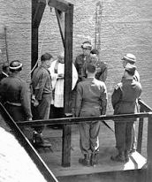 Reportedly, this is an image of Schöngarth on the gallows minutes before his execution by hanging. Albert Pierrepoint was the executioner. Photo by anonymous (c. May 1946).