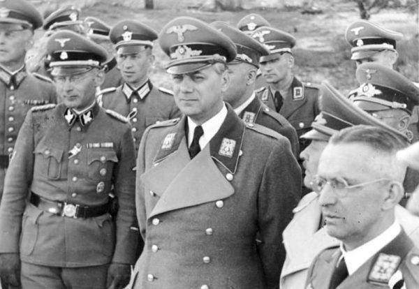 Alfred Rosenberg (center) and Alfred Meyer (lower far right corner). Photo by anonymous (c. June 1942). German Federal Archives. Bundesarchiv, Bild 146-1969-067-01/CC-BY-SA 3.0. PD-CCA-Share Alike 3.0 Germany. Wikimedia Commons.