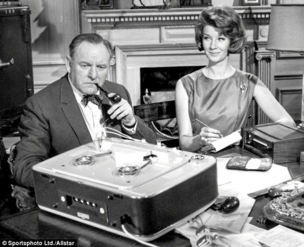 Bernard Lee (pictured with Lois Maxwell as Miss Moneypenny) played “M” in the James Bond films. Photo by anonymous (date unknown). ©️Sportsphoto/Allstar.