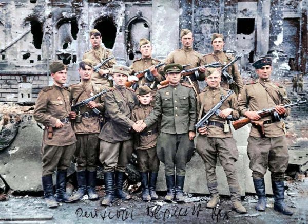 Soviet soldiers in front of the German Reichstag. Photo by anonymous (c. May 1945). PD-Russian Public Domain.