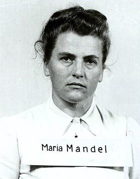 Maria Mandl after her arrest on 10 August 1945. Photo by anonymous (c. 1945). PD-U.S. Government. Wikimedia Commons.