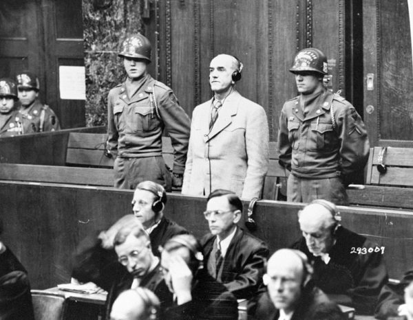Oswald Pohl receives his sentence of death by hanging in the Pohl trial. Photo by anonymous (3 November 1947). PD-U.S. Government. Wikimedia Commons.
